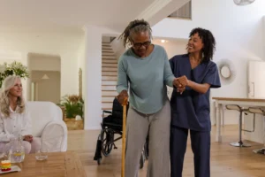 Caregiver assisting woman with cane – home health aide services Baltimore, MD
